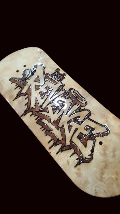 Canadian maple fingerboard deck with light wood finish and graffiti-style Revenge graphic