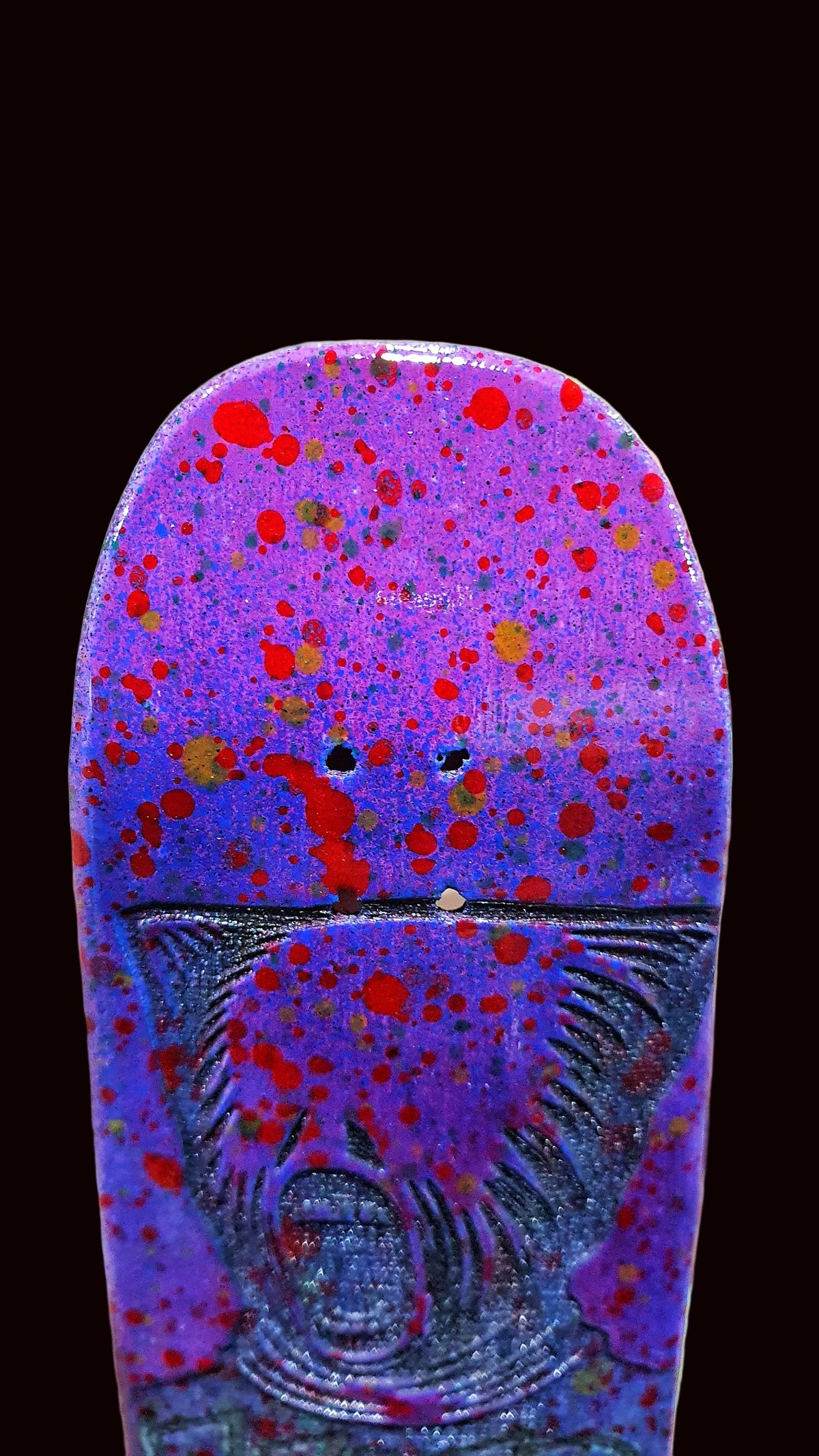 Purple fingerboard deck close-up with red splatter and animal face artwork.