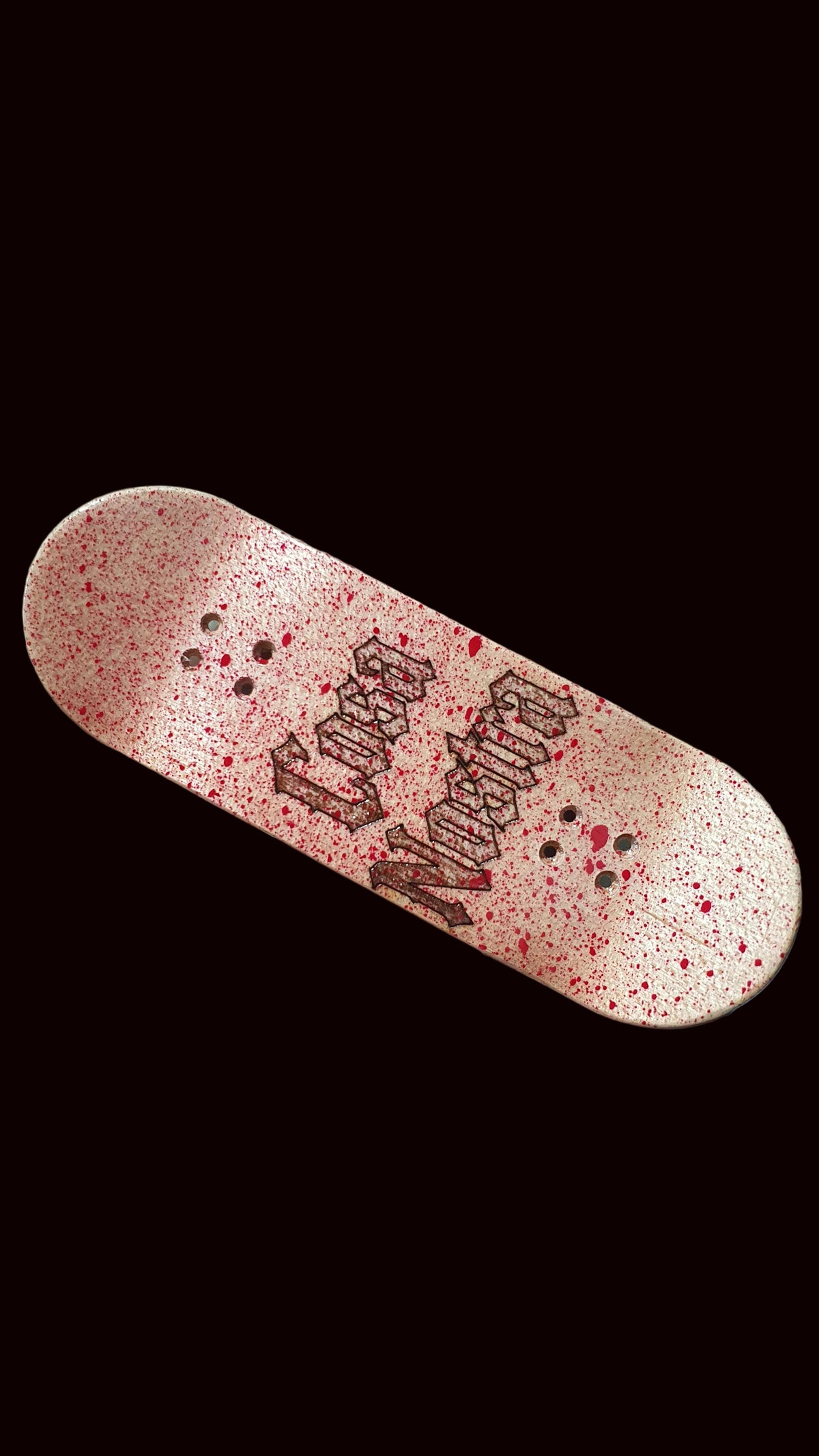 Popsicle fingerboard deck, pink speckled finish with black graffiti-style graphic
