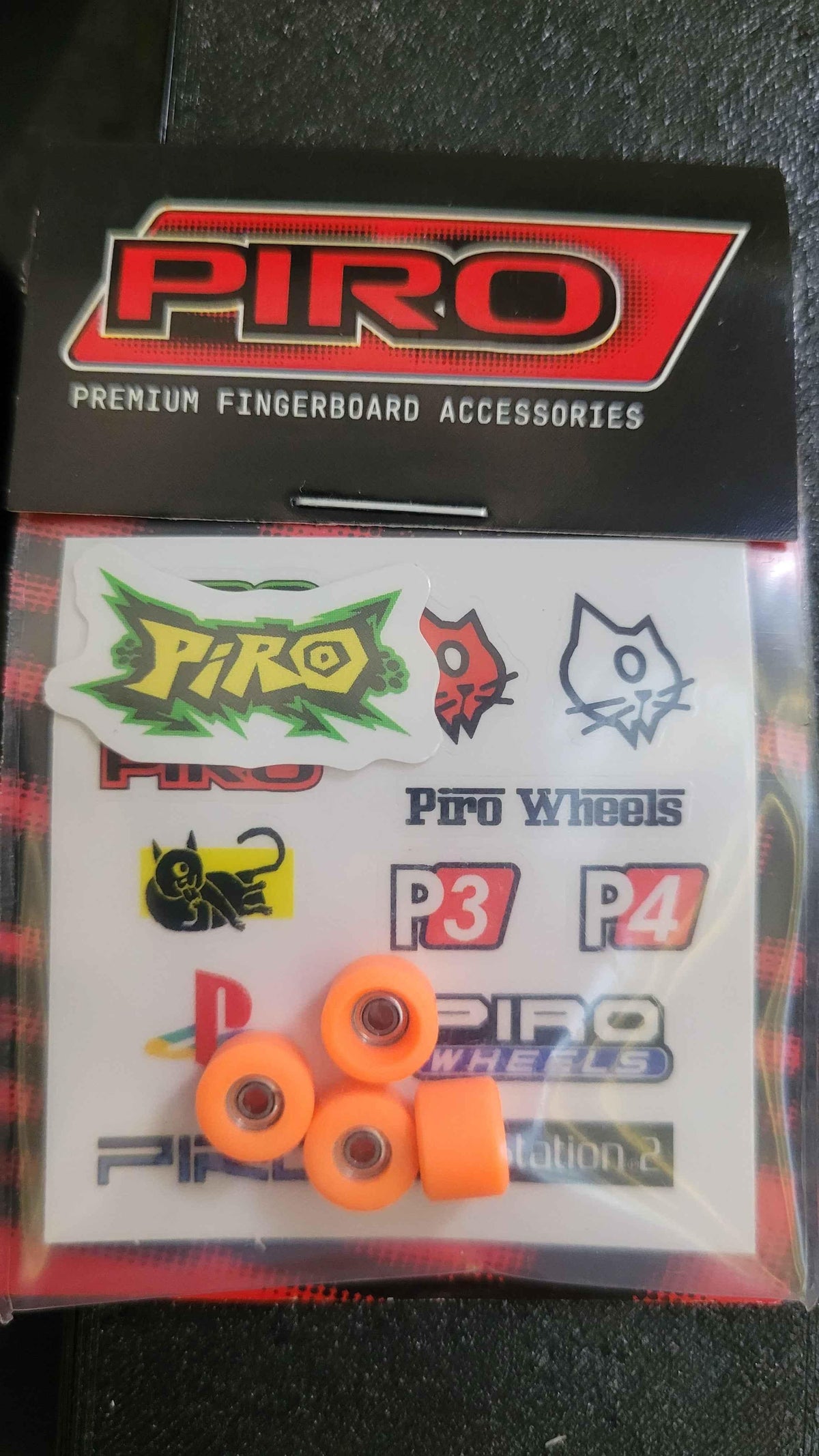 Piro premium fingerboard wheels and stickers set in packaging.