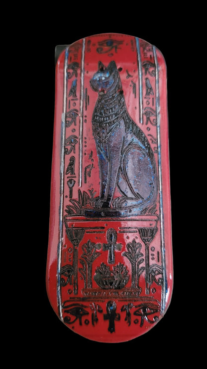 Decorative red box with black designs on a textured surface