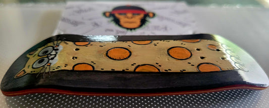 Fingerboard deck top with cat face and orange polka dots on a yellow panel