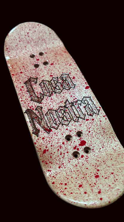 Popsicle fingerboard deck, white-pink speckled finish with black graphic and mounting holes