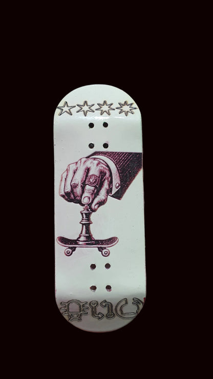 White fingerboard deck with purple boxing-hand graphic, stars at top, and bottom script