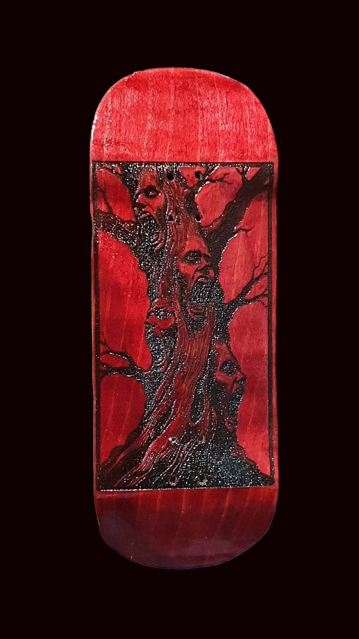 Red fingerboard deck with deer graphic and speckled glitter top