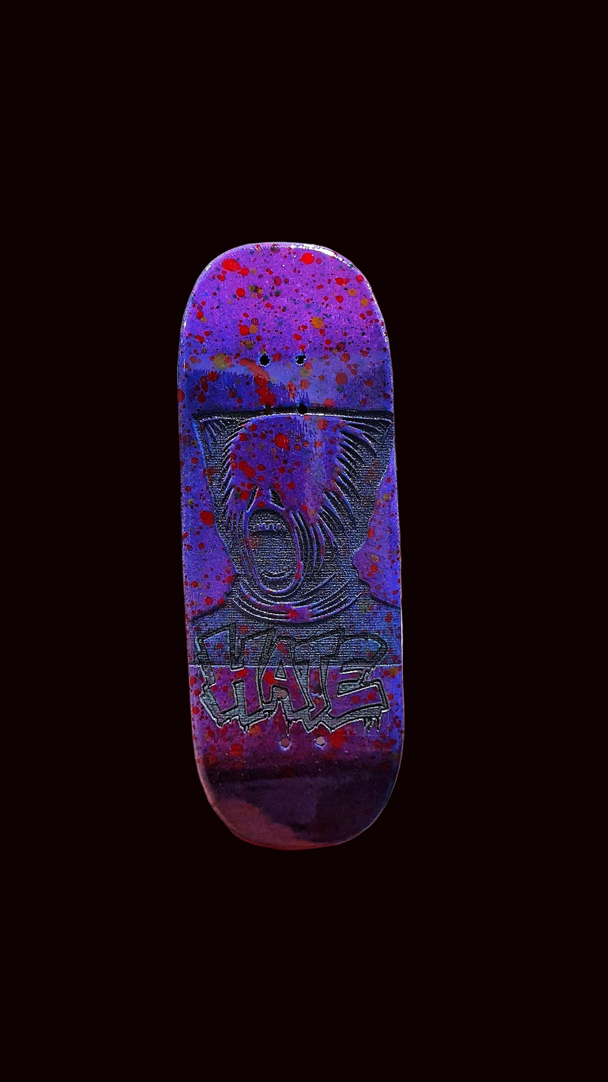 Purple fingerboard deck with red-blue splatter and centered animal face illustration.