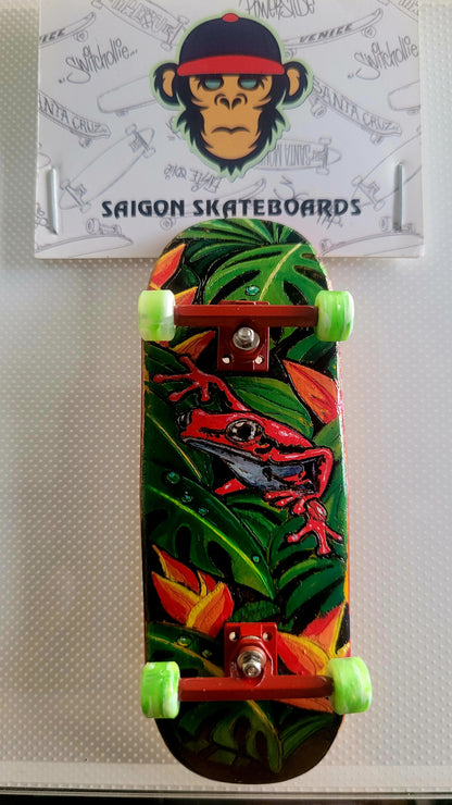 Green jungle fingerboard deck with red lizard graphic and lime green trucks