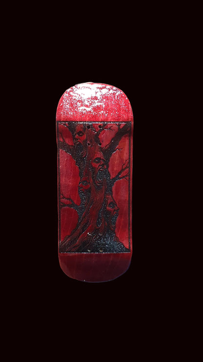 Red fingerboard deck with centered deer graphic and glossy speckled finish