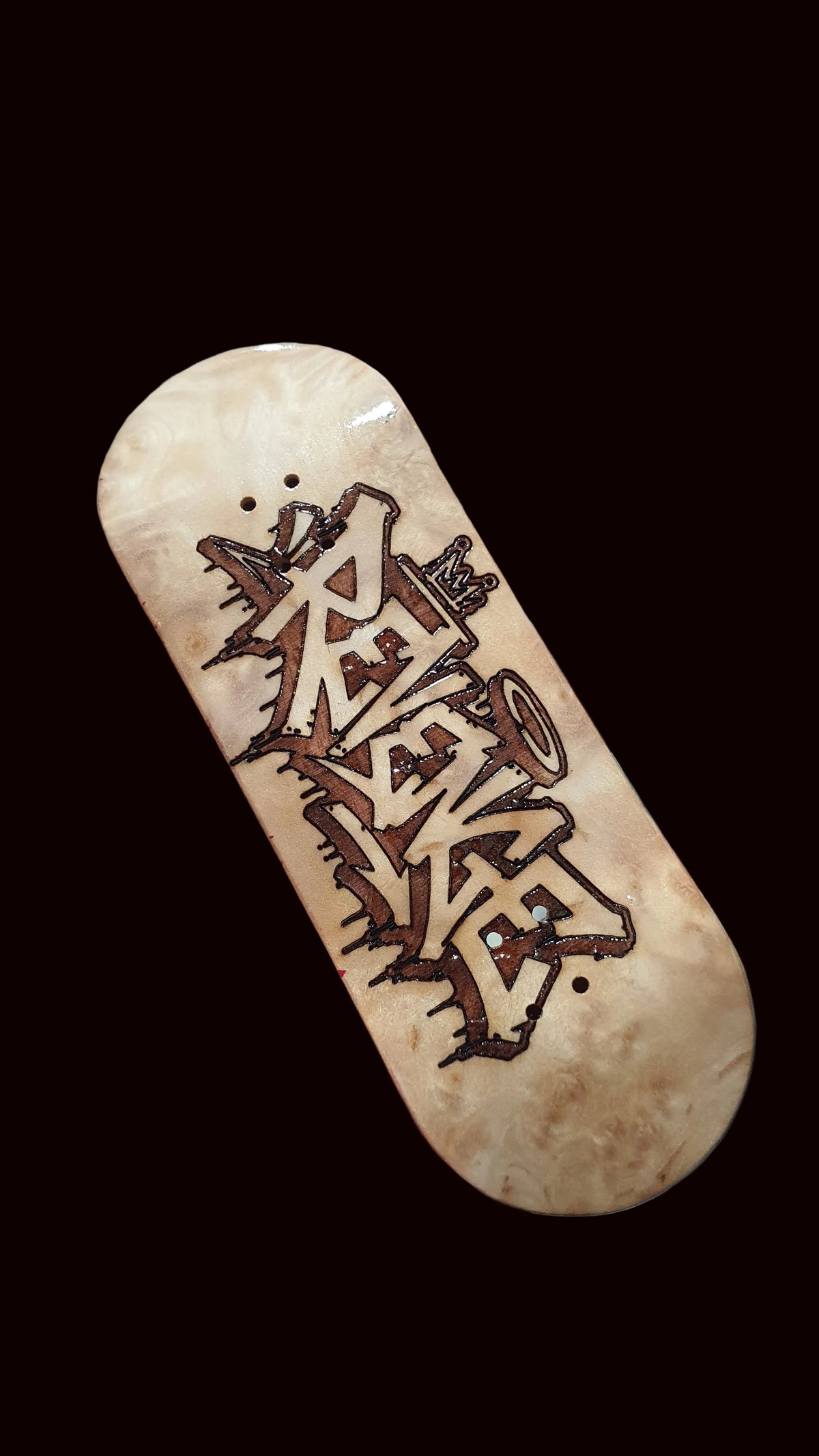 Canadian maple fingerboard deck, light wood top with graffiti-style Revenge lettering