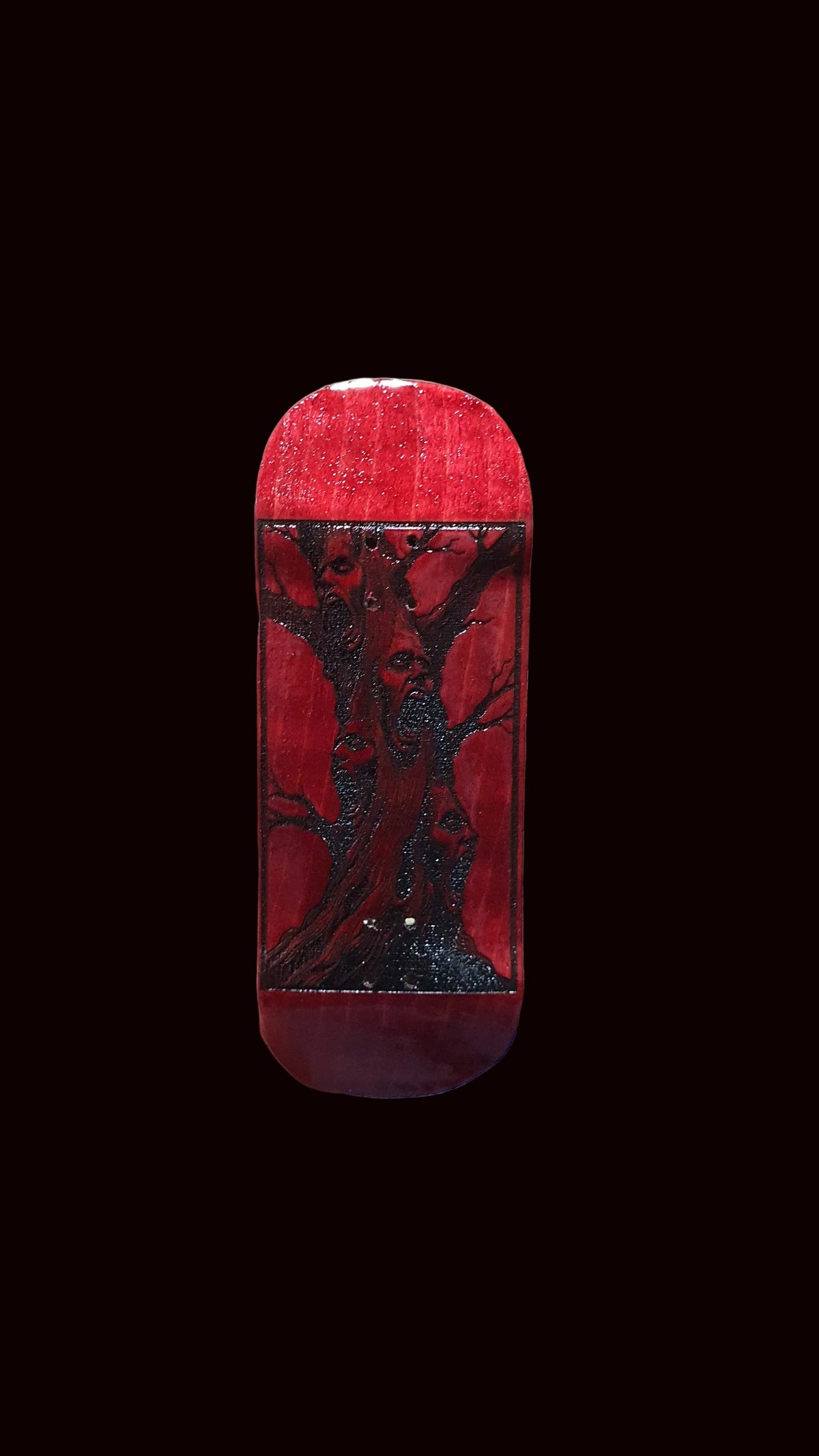 Red fingerboard deck with dark deer face graphic on top
