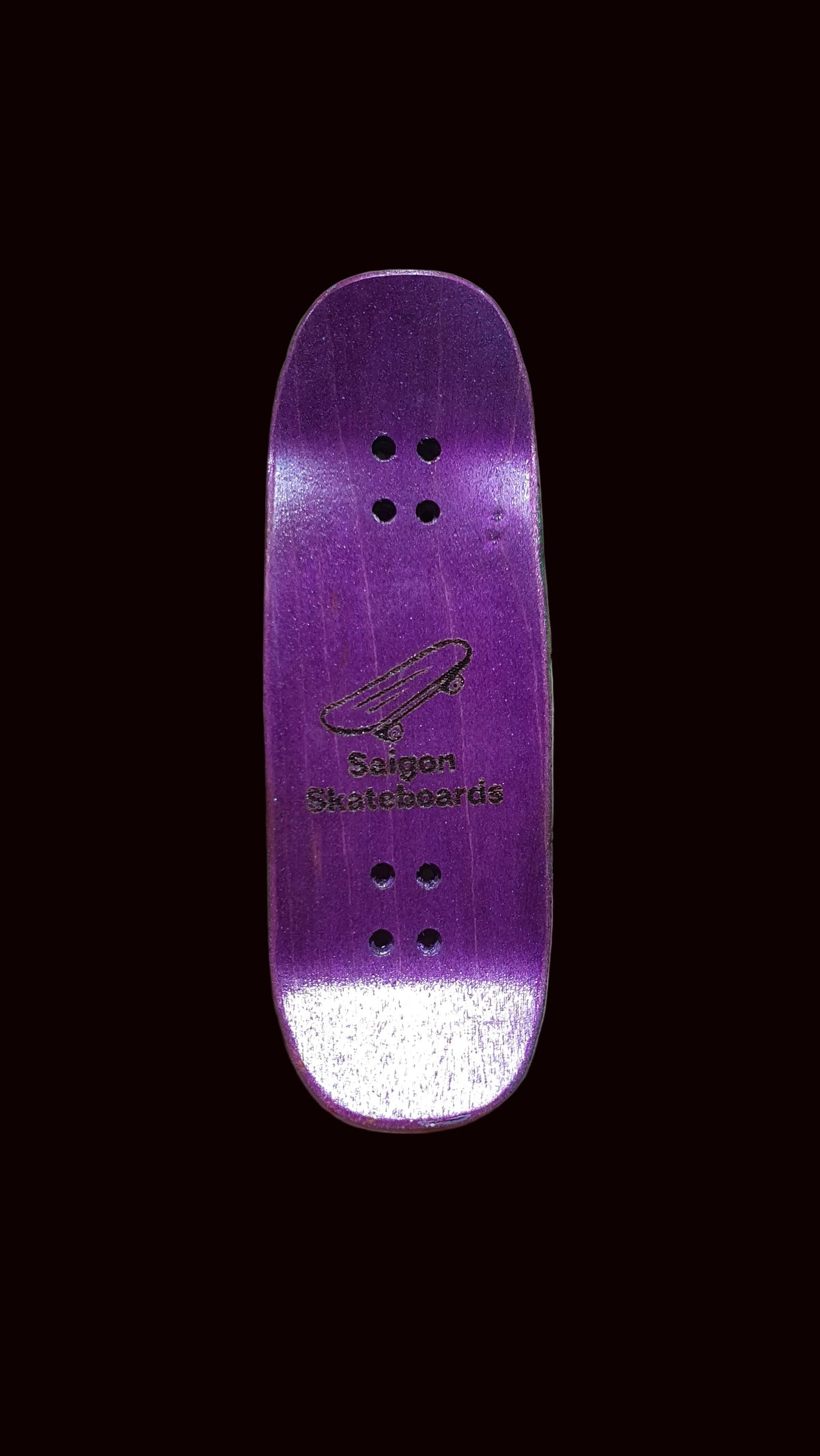 Purple fingerboard deck with small centered graphic and three grip bolt holes.
