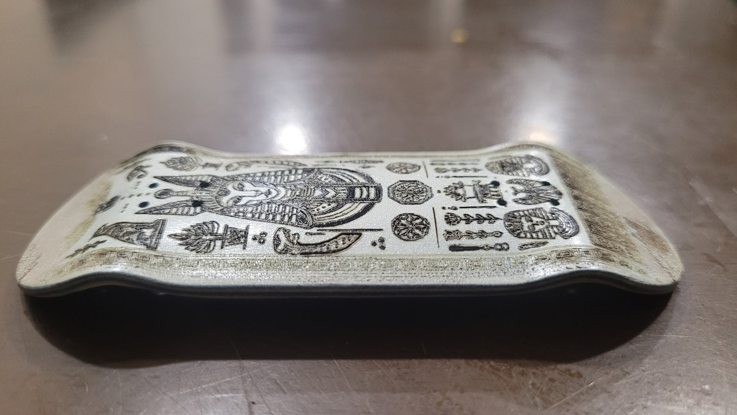 Decorative stone with intricate carvings on a wooden surface