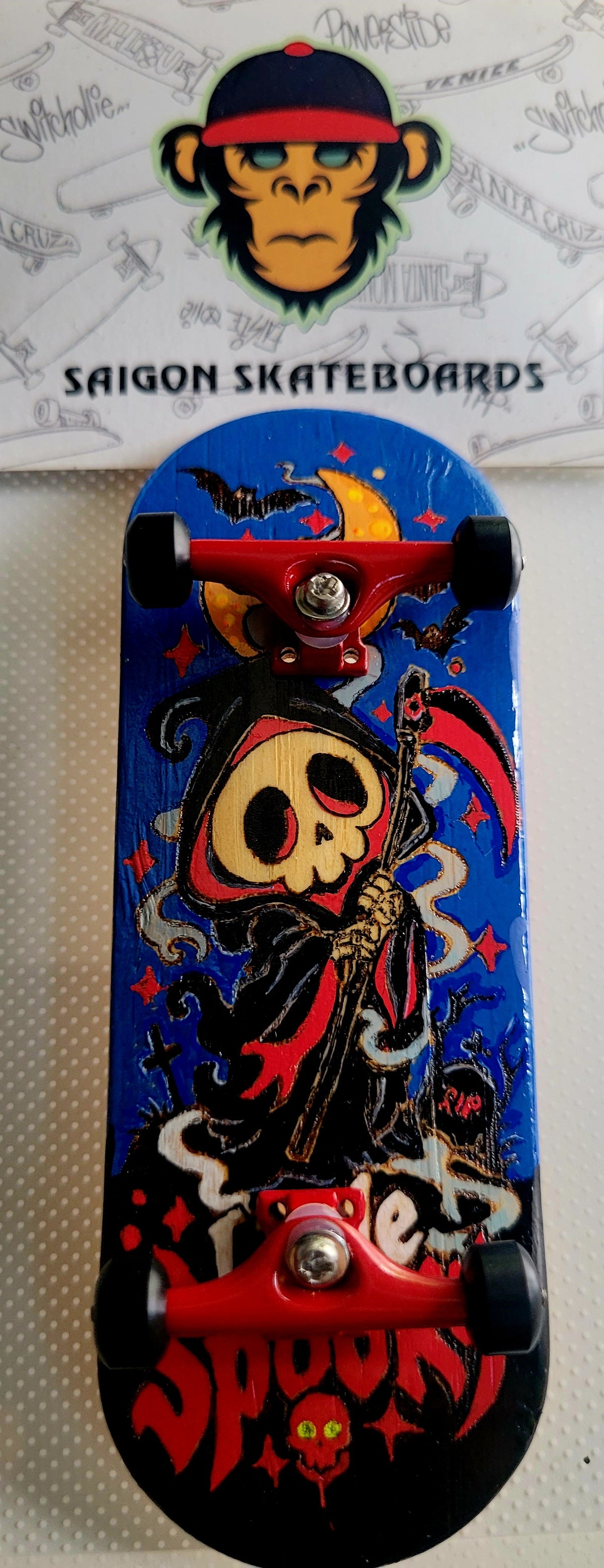 Blue fingerboard deck with witch skull illustration, stars, and red "Little Spooky" title
