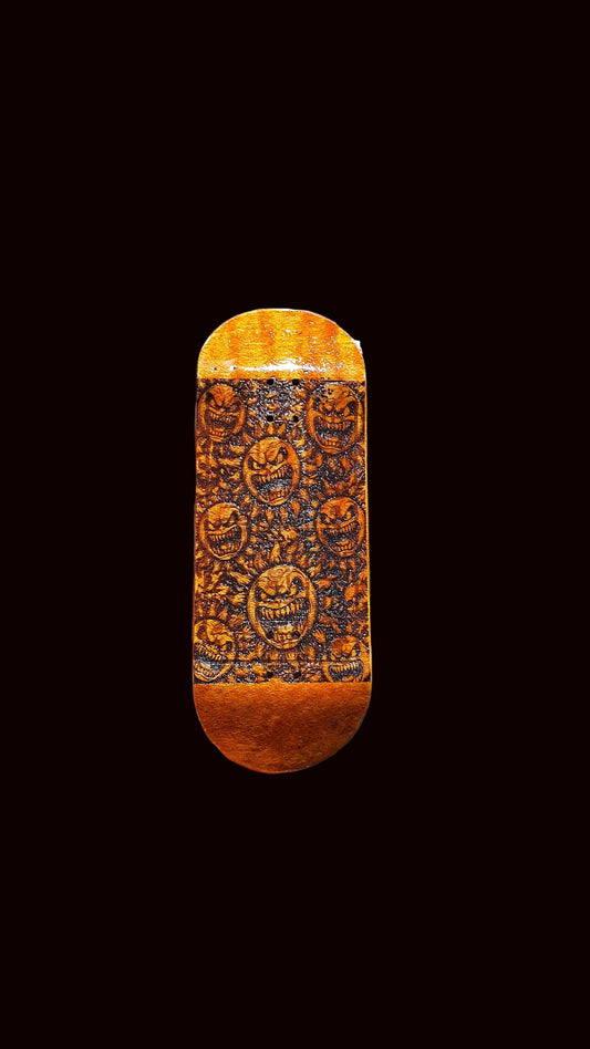 Fingerboard deck end view, orange stained wood with dark ornate face pattern