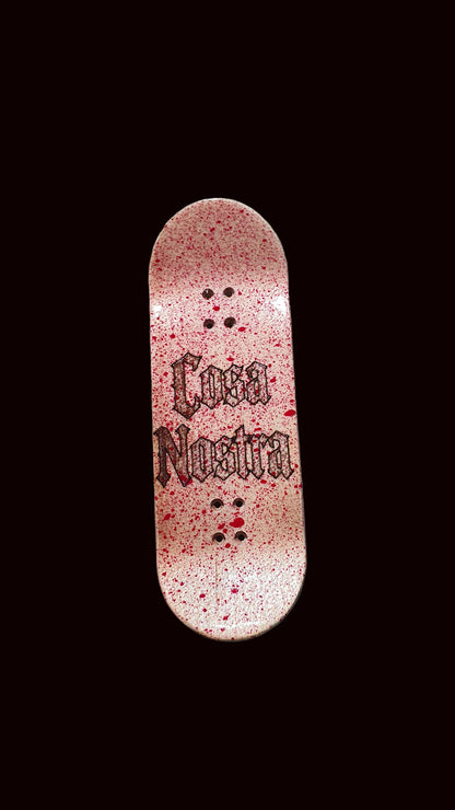 Popsicle fingerboard deck, pink speckled finish with black text graphic and mounting holes