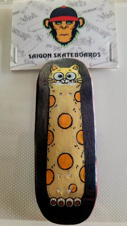 Fingerboard deck with cat graphic, dark sides, yellow speckled background