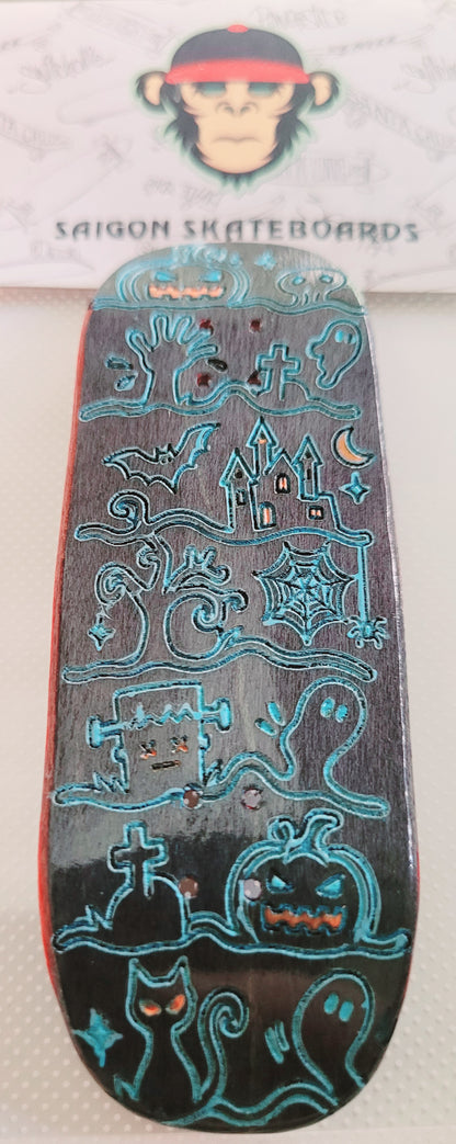 Skateboard deck with blue Ghost Town-style illustration, red tail edge, no trucks