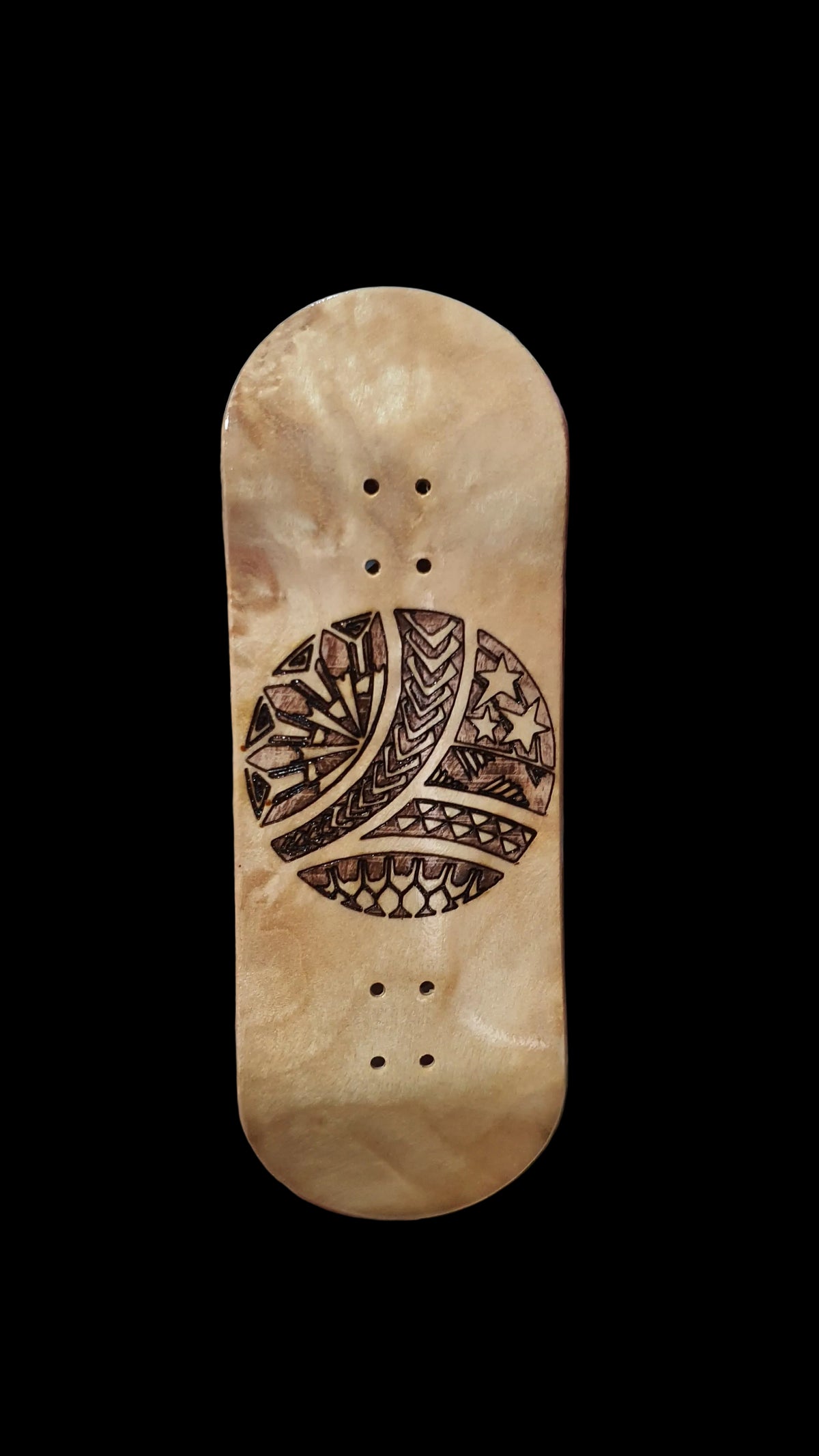 Fingerboard deck with light wood finish, tribal-style graphic, and 4 mounting holes