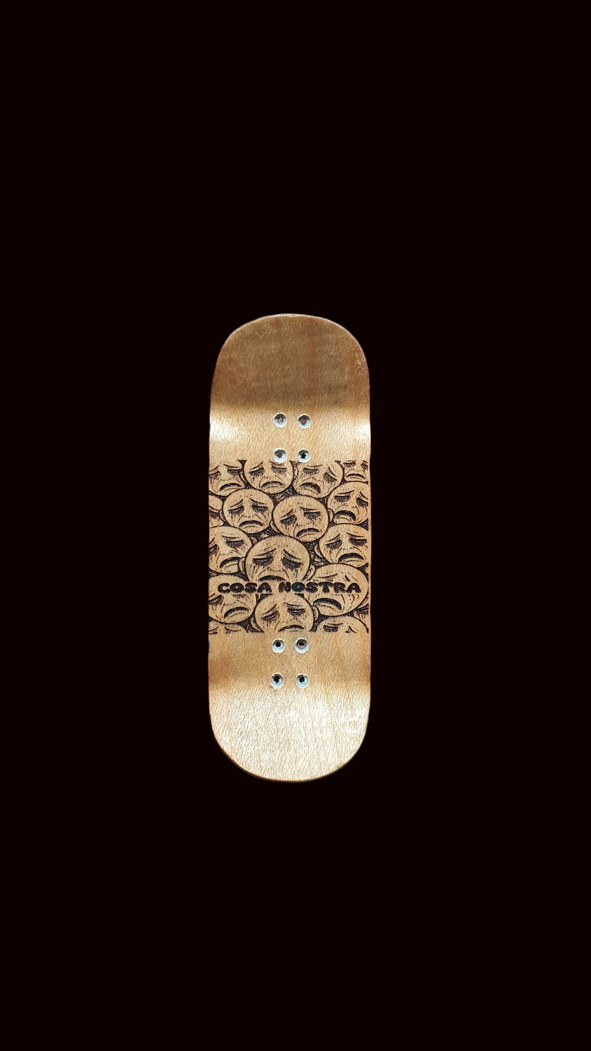 Gold fingerboard deck with line-art faces and rivet dot details on top