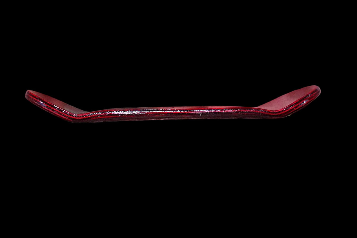 Red fingerboard deck side view showing curved underside and lip
