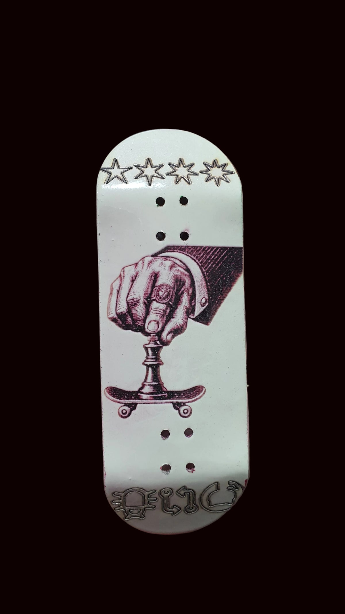 White fingerboard deck with purple boxing-hand illustration, stars above, and three dot rows