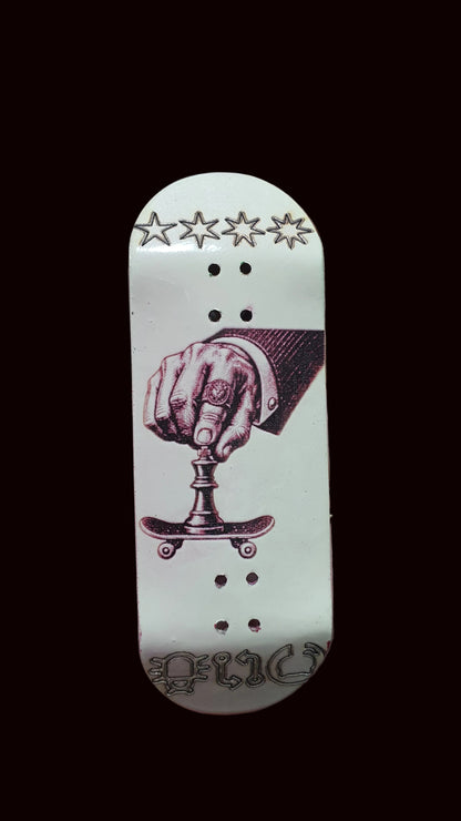 White fingerboard deck with purple boxing-hand illustration, stars above, and three dot rows
