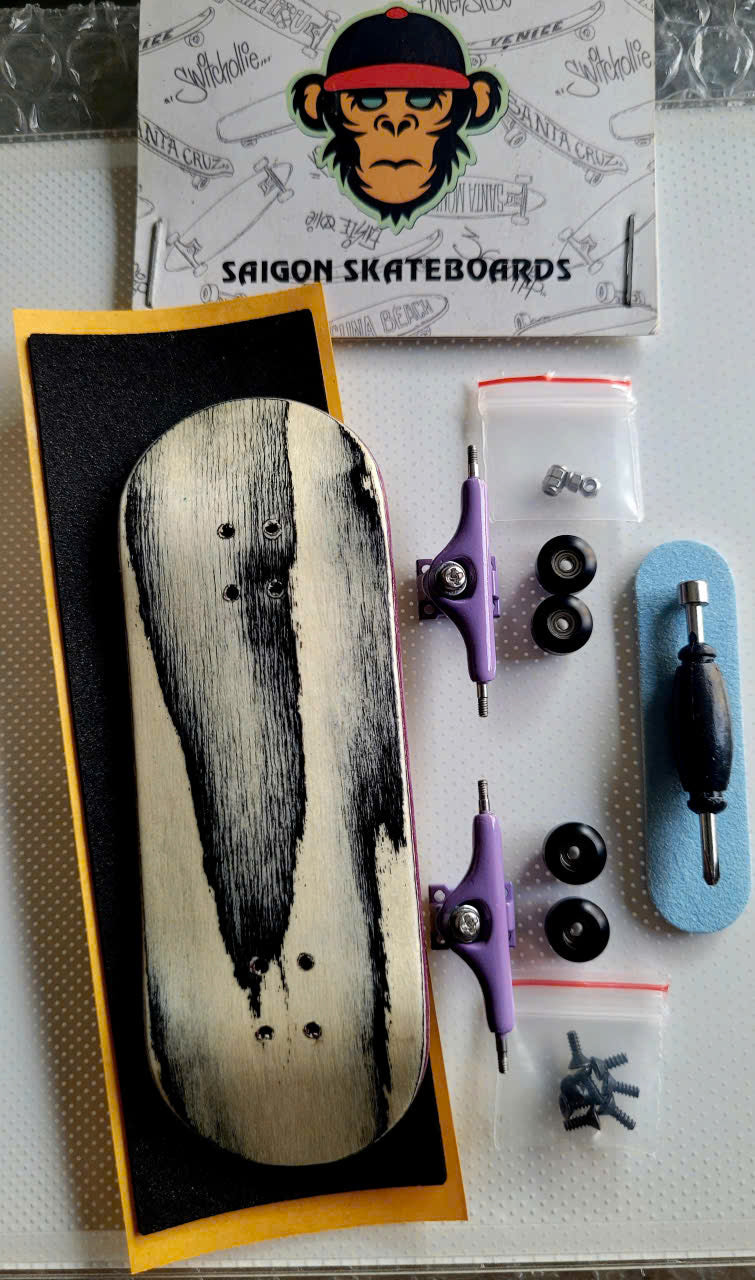 Fingerboard set with black-streaked wood deck, purple trucks, wheels, tool, and hardware